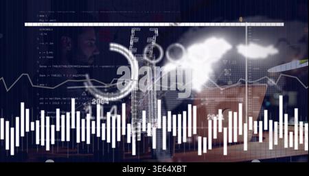 Analyzing man in dark sweater leaning over laptop at desk, with waveform charts, mug, copy space Stock Photo