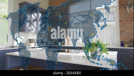 Displaying blue hologram world map over white island countertop in residential kitchen, markers Stock Photo