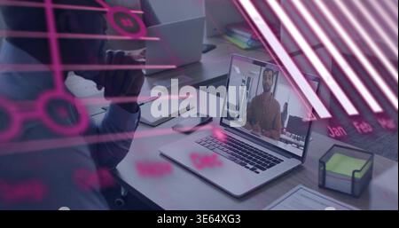 Displaying laptop showing remote coworker wearing business top at office desk, neon sticky notes Stock Photo