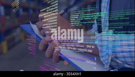 Holding blue clipboard, man in blue-shirt writing with pen in storage with code overlay, copy space Stock Photo