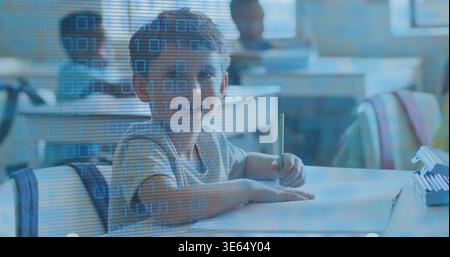 Writing pupil holding green pencil on paper at school in light short-sleeve tee with binary overlay Stock Photo