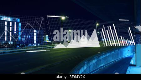Displaying curved multilane highway overpass with translucent line, area and bar charts at night Stock Photo