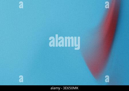 An image of a red streak on a blue surface with a grainy texture, possibly a digitally created or edited image, with the red paint appearing to be ble Stock Photo