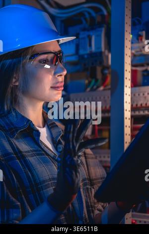 Electrical specialist working with tablet during system inspection. Engineering control. Stock Photo