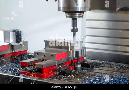 Metal processing machine. Machining center. CNC vertical machining center. Computer control. Metal milling equipment. Metal shavings. Machines production tools Industrial Stock Photo
