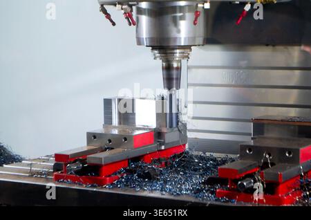 Metal processing machine. Machining center. CNC vertical machining center. Computer control. Metal milling equipment. Metal shavings. Machines production tools Industrial Stock Photo