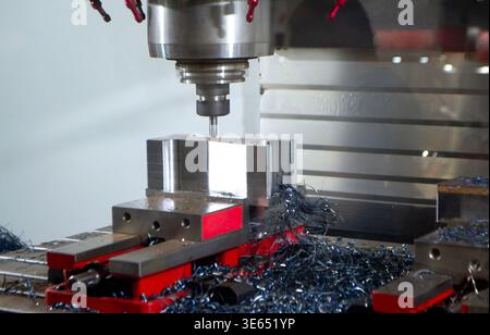 Metal processing machine. Machining center. CNC vertical machining center. Computer control. Metal milling equipment. Metal shavings. Machines production tools Industrial Stock Photo