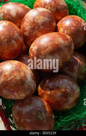 Close up of natural dyed Easter eggs colored with onion skins. Rustic texture background with organic patterns, traditional holiday concept. Stock Photo