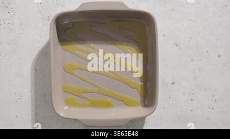 Drizzled oil inside empty ceramic baking dish preparation Stock Photo