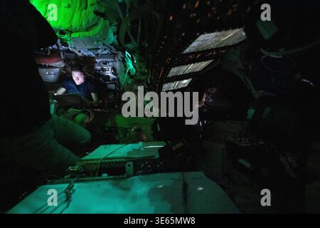 Orion Capsule, Outer Space. 03rd Apr, 2026. Orion Capsule, Outer Space. 03 April, 2026. NASA astronaut and Artemis II mission specialist Christina Koch is illuminated by a screen inside the darkened Orion spacecraft on the third day of the mission around the far side of the Moon, April 3, 2026, from Space. Canadian Space Agency astronaut Jeremy Hansen, right, is seen in profile peering out of one of Orion's windows. Lights are turned off to avoid glare on the windows. Credit: NASA/NASA/Ģ����ý Live News Stock Photo