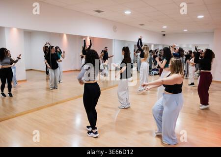 Group of women dancing during a fitness workout rehearsal Stock Photo