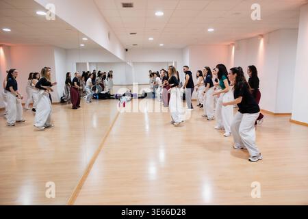 Group of young adults rehearsing dance routine in studio Stock Photo