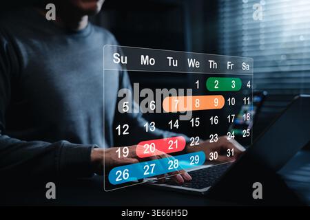 Schedule Planning and Calendar Management Concept. Man using laptop with virtual calendar. task scheduling, date planning, deadline tracking, time Stock Photo