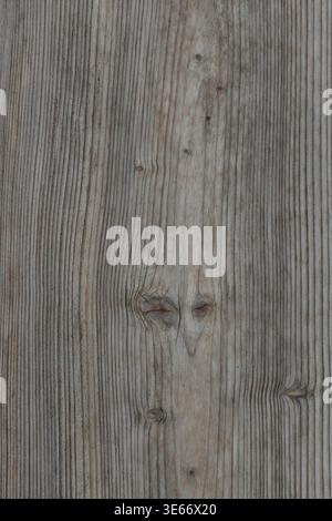 Close-up of vertical weathered wood grain with natural knots and fine lines, ideal for rustic backgrounds, organic textures, and wooden surface design Stock Photo