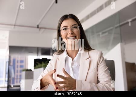 Webcam view of pretty businesslady conduct virtual meeting in office Stock Photo