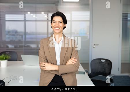 Businesswoman or corporate coach stands in conference room Stock Photo