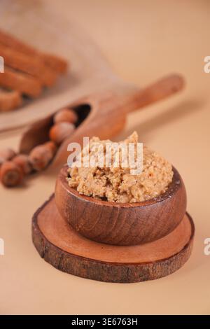 hazelnut butter placed in a wooden bowl on a simple surface Stock Photo