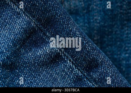 Detailed blue denim fabric texture background with visible stitching pattern Stock Photo