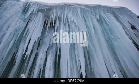 Forming icicles creating a frozen wall of ice during harsh winter conditions Stock Photo