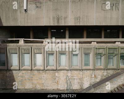 Abandoned Tallinn City Hall concrete facade with rows of recessed windows and weathered brickwork, Estonia, March 2026 Stock Photo