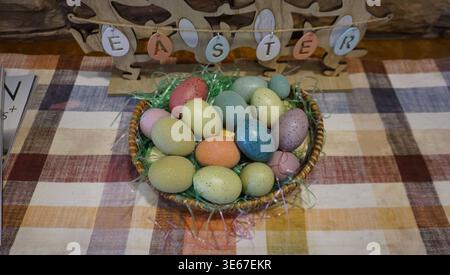 Easter Basket with Colorful Eggs and Spring Decorations Stock Photo
