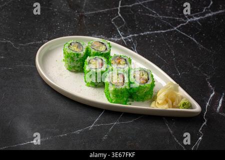 Sushi rolls with green coating and ginger Stock Photo
