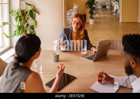 High angle view of diverse professionals brainstorming ideas and collaborating on creative project in office Stock Photo