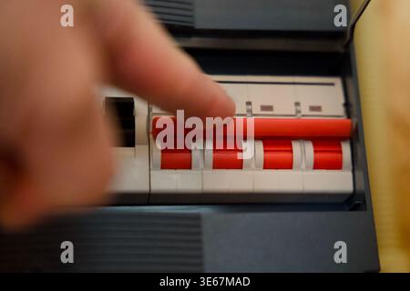 Emergency Power Activation by Switching Circuit Breakers in Electrical Fuse Box During Blackout Stock Photo