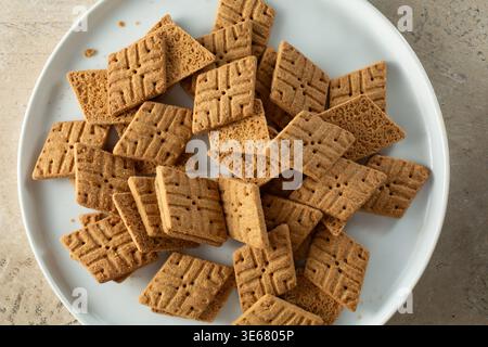 A top down view of a pile of thin gluten-free lemon cookies, on a plate. Stock Photo