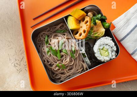 A top down view of a bento box, featuring soba noodles. Stock Photo