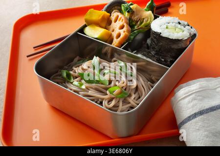 A view of a bento box, featuring soba noodles. Stock Photo