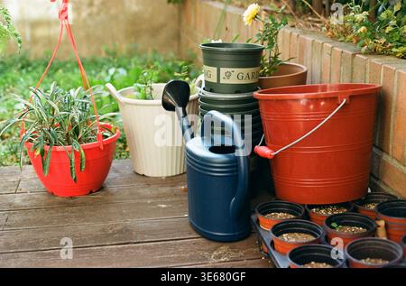 Jeju City, Jeju-do, South Korea - February 17, 2026: Watering can, buckets, and flower pots arranged on a garden deck Stock Photo