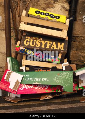 A stack of wooden and cardboard fruit and vegetable boxes left out for roadside collection in Bradford on Avon, Wiltshire, England Stock Photo