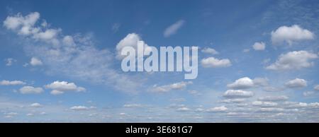 heaven skies blue and clear, with thin, puffy, transparent clouds. and moon is visible through them. sun shines brightly, making sky even brighter. sc Stock Photo