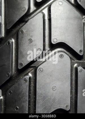 This high-quality macro shot showcases the intricate and rugged tread pattern of a modern off-road tire, highlighting the durable black rubber texture Stock Photo