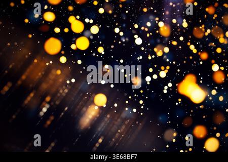 Abstract image featuring golden bokeh lights against a dark background, with blurred circles and streaks of light suitable for festive and decorative Stock Photo