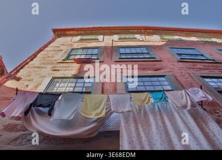 Hanging Laundry on Old Building Facade Stock Photo