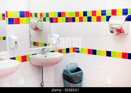 Bright interior of a public restroom with sinks in a shopping and entertainment center Stock Photo