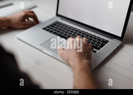 Successful male businessman freelancer sits in office and types text on laptop. The guy is working Stock Photo