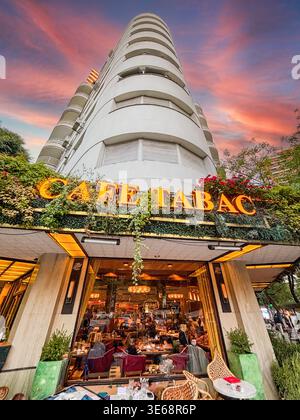 Low angle shot focusing on the Cafe Tabac neon sign. Modern style building architecture on the most famous corner of Buenos Aires. Stock Photo