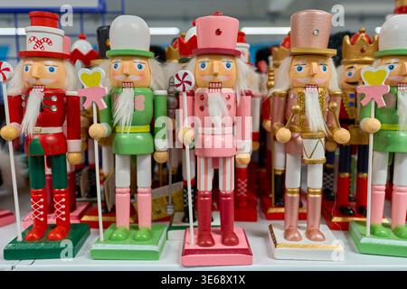 Traditional wooden Christmas nutcracker figurines in colorful uniforms standing in a row. Festive holiday decorations and gifts. Stock Photo