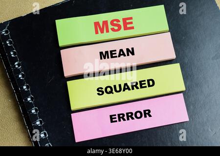 Concept of MSE - Mean Squared Error write on sticky notes isolated on Wooden Table. For data science, statistics and mathematical accuracy Stock Photo