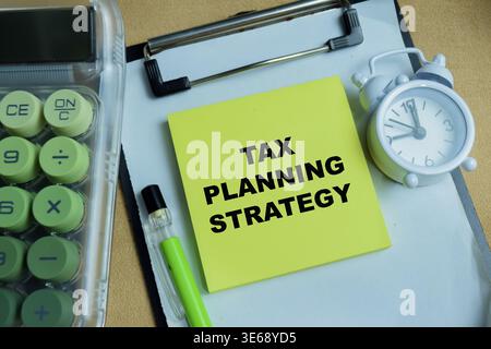 Concept of tax planning strategy write on sticky notes isolated on Wooden Table. For Financial deadlines, accounting and tax season preparation Stock Photo