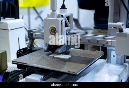 The process of printing on 3D printer. 3D printer creating model from molten plastic close-up. Molten plastic flowing of extruder and forming three-dimensional volumetric object. Additive technologies Stock Photo