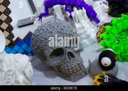 3D printed different art objects. Objects printed on 3D printer from melted colored plastic. Model gray skull created on 3D printer from threads of molten plastic. Modern new additive technologies Stock Photo