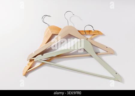 Set of Wooden and Colored Hangers Isolated on Light Background Stock Photo