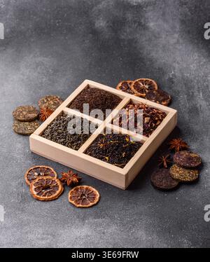 A box of various dry teas, black, green, herbal, and fruit, with flavored additives. A set of different tea varieties as a backdrop for your design Stock Photo
