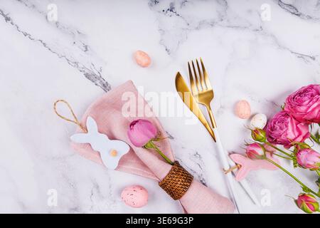 Easter Table Decor with Blue Napkin and Pink Bunny Stock Photo
