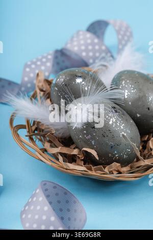 Easter eggs with white feathers in nest spring decoration Stock Photo