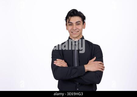 Businessman in black suit standing with arms crossed Stock Photo